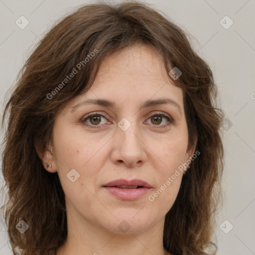 Joyful white adult female with long  brown hair and brown eyes