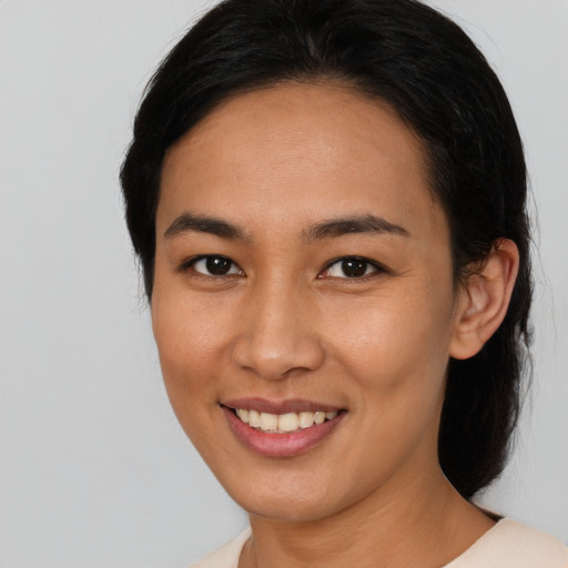 Joyful asian young-adult female with medium  black hair and brown eyes