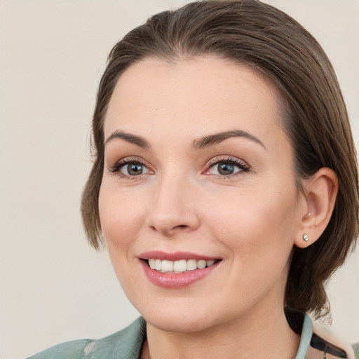 Joyful white young-adult female with medium  brown hair and brown eyes