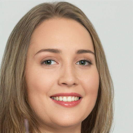 Joyful white young-adult female with long  brown hair and green eyes