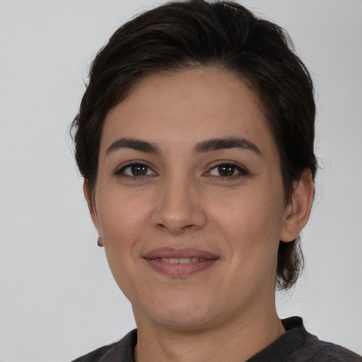 Joyful white young-adult female with medium  brown hair and brown eyes