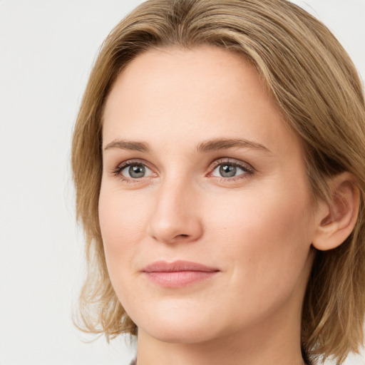 Joyful white young-adult female with medium  brown hair and blue eyes