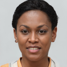 Joyful black young-adult female with short  black hair and brown eyes