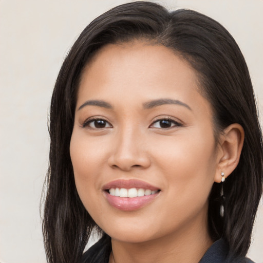 Joyful latino young-adult female with long  brown hair and brown eyes