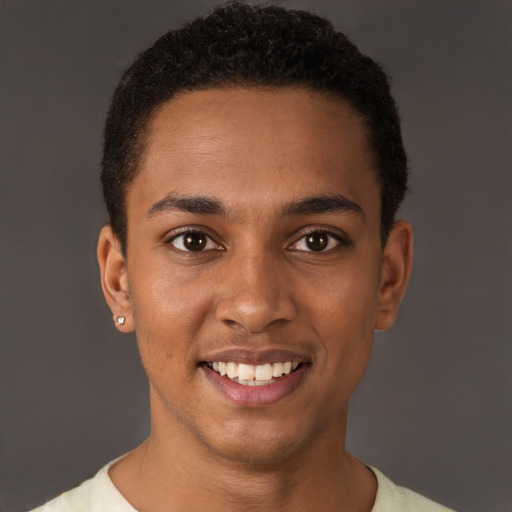 Joyful black young-adult male with short  brown hair and brown eyes