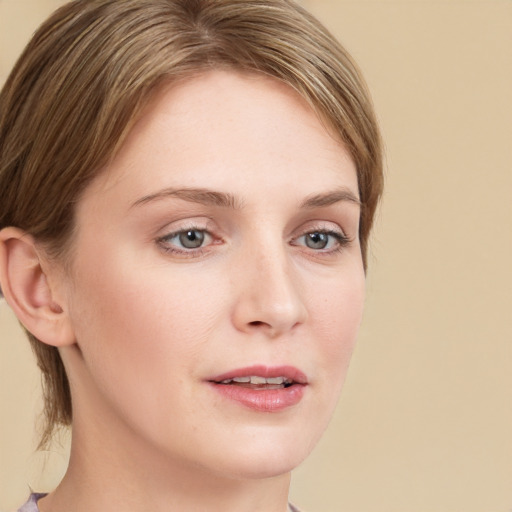 Joyful white young-adult female with medium  brown hair and green eyes