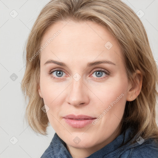 Joyful white young-adult female with medium  brown hair and blue eyes