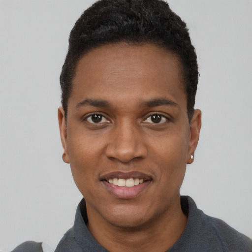 Joyful black young-adult male with short  black hair and brown eyes