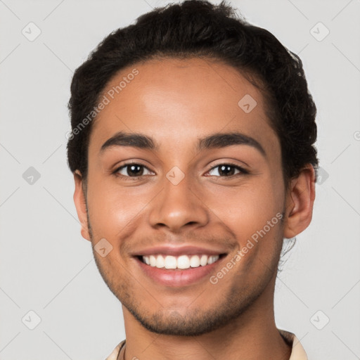 Joyful latino young-adult male with short  brown hair and brown eyes