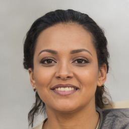 Joyful latino young-adult female with medium  black hair and brown eyes