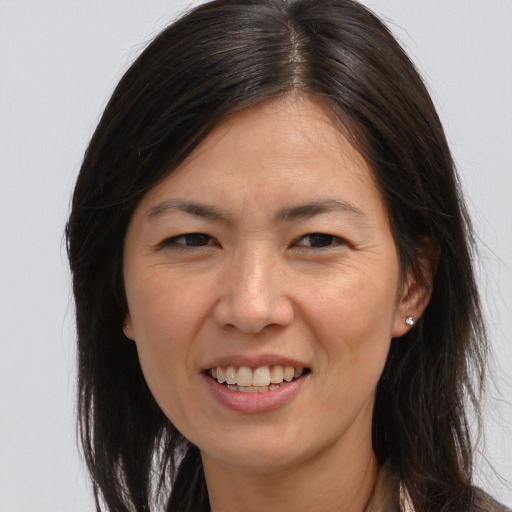 Joyful white adult female with long  brown hair and brown eyes
