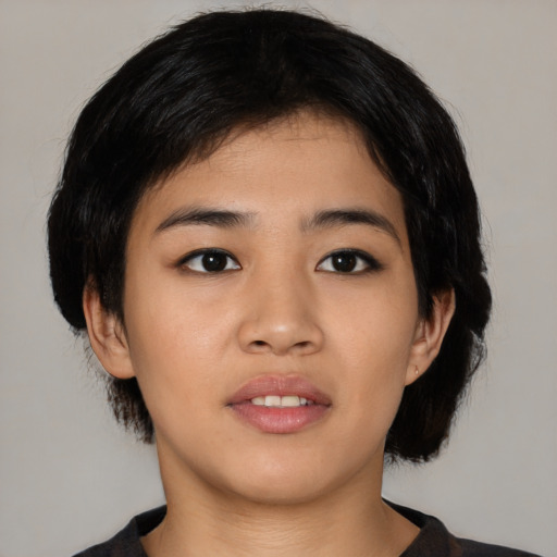 Joyful asian young-adult female with medium  black hair and brown eyes