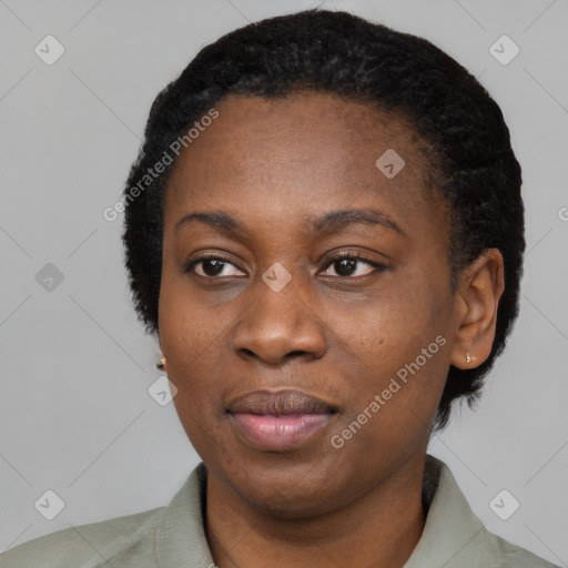 Joyful black young-adult female with short  black hair and brown eyes