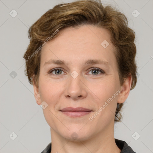 Joyful white adult female with medium  brown hair and grey eyes