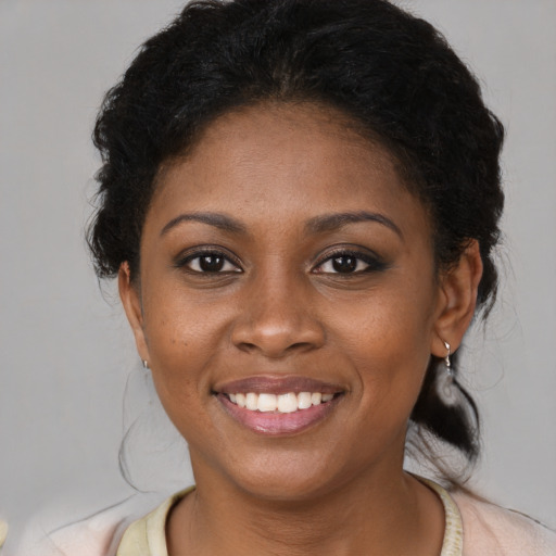 Joyful black young-adult female with medium  brown hair and brown eyes