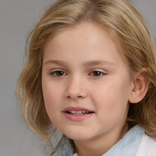 Joyful white child female with medium  brown hair and brown eyes