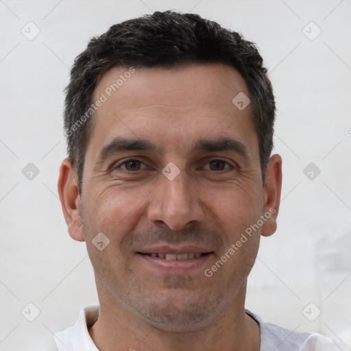 Joyful white adult male with short  brown hair and brown eyes