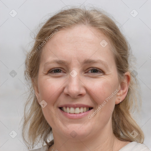 Joyful white adult female with medium  brown hair and blue eyes