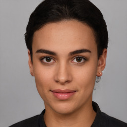 Joyful latino young-adult female with short  brown hair and brown eyes