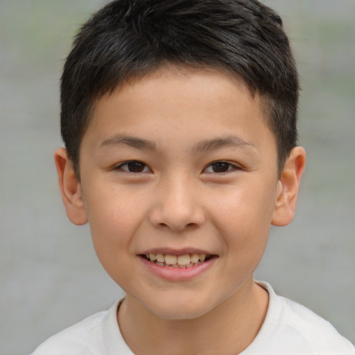 Joyful white child male with short  brown hair and brown eyes