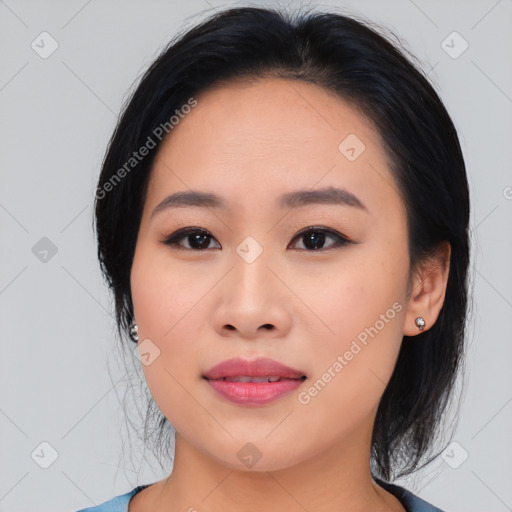 Joyful asian young-adult female with medium  black hair and brown eyes