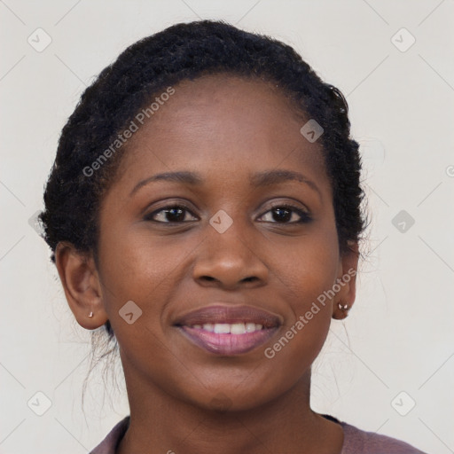 Joyful black young-adult female with long  brown hair and brown eyes