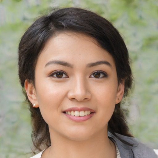 Joyful latino young-adult female with medium  brown hair and brown eyes