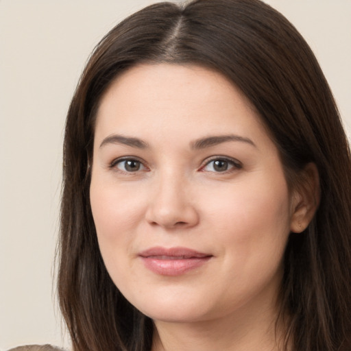 Joyful white young-adult female with long  brown hair and brown eyes