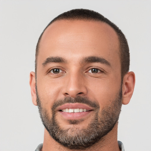 Joyful white young-adult male with short  black hair and brown eyes