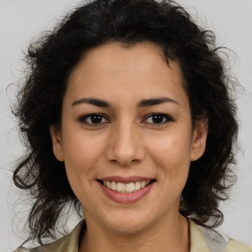 Joyful latino young-adult female with medium  brown hair and brown eyes