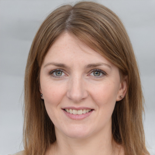 Joyful white young-adult female with medium  brown hair and grey eyes