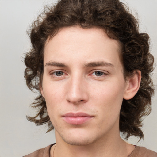 Joyful white young-adult male with medium  brown hair and brown eyes