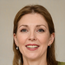 Joyful white adult female with medium  brown hair and green eyes