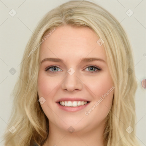 Joyful white young-adult female with long  brown hair and blue eyes