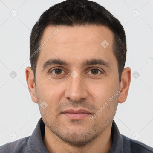 Joyful white young-adult male with short  black hair and brown eyes