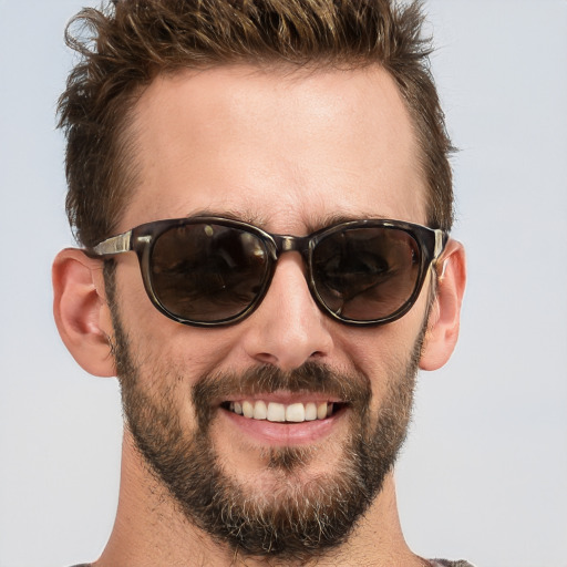 Joyful white adult male with short  brown hair and brown eyes