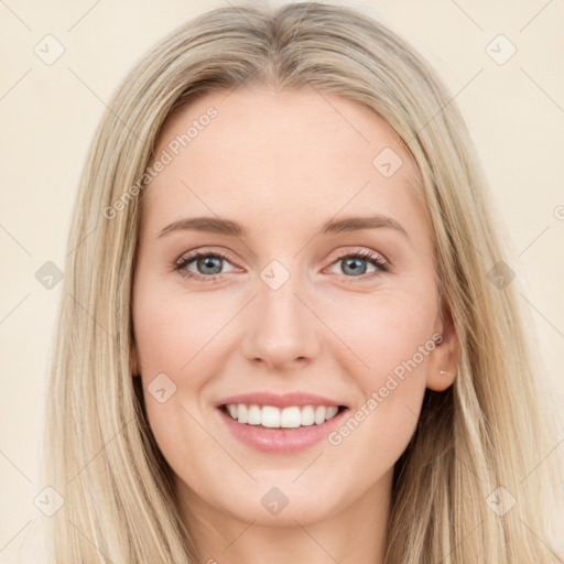 Joyful white young-adult female with long  brown hair and blue eyes