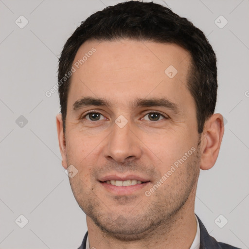 Joyful white young-adult male with short  black hair and brown eyes