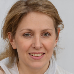 Joyful white adult female with medium  brown hair and blue eyes