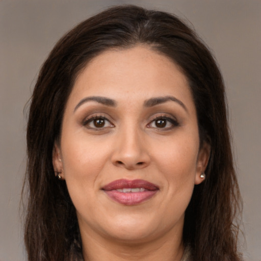 Joyful white adult female with long  brown hair and brown eyes