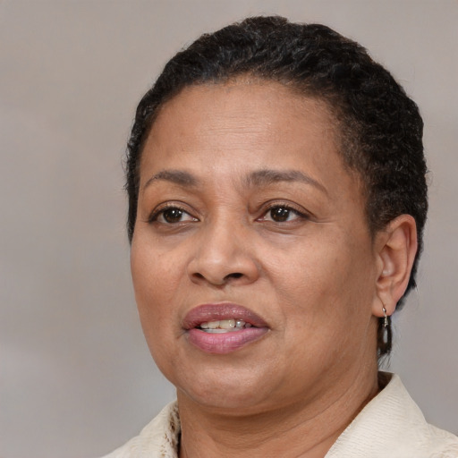 Joyful black adult female with short  brown hair and brown eyes