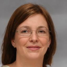 Joyful white adult female with medium  brown hair and blue eyes