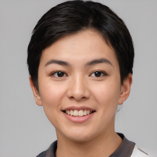 Joyful asian young-adult female with short  brown hair and brown eyes