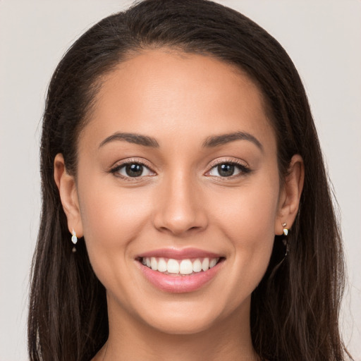 Joyful white young-adult female with long  brown hair and brown eyes