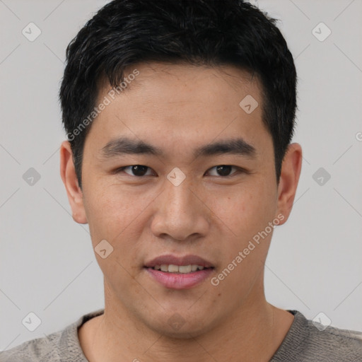 Joyful asian young-adult male with short  black hair and brown eyes