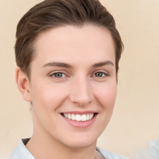 Joyful white young-adult female with short  brown hair and grey eyes