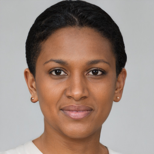 Joyful black young-adult female with short  brown hair and brown eyes