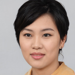 Joyful asian young-adult female with medium  black hair and brown eyes