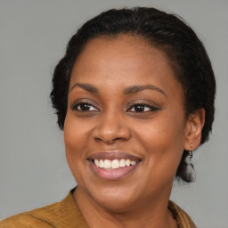 Joyful black adult female with medium  brown hair and brown eyes