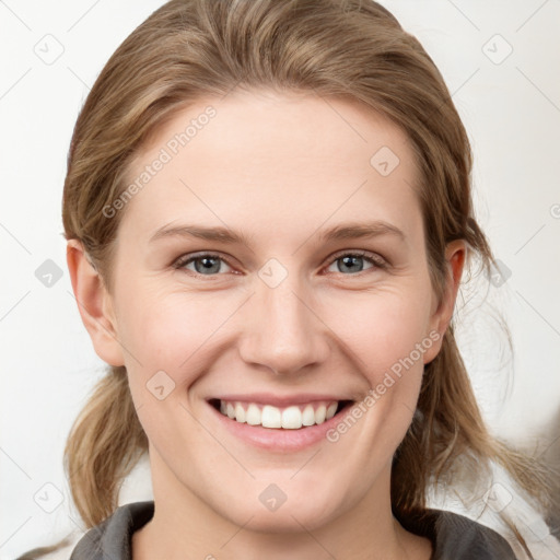 Joyful white young-adult female with medium  brown hair and grey eyes